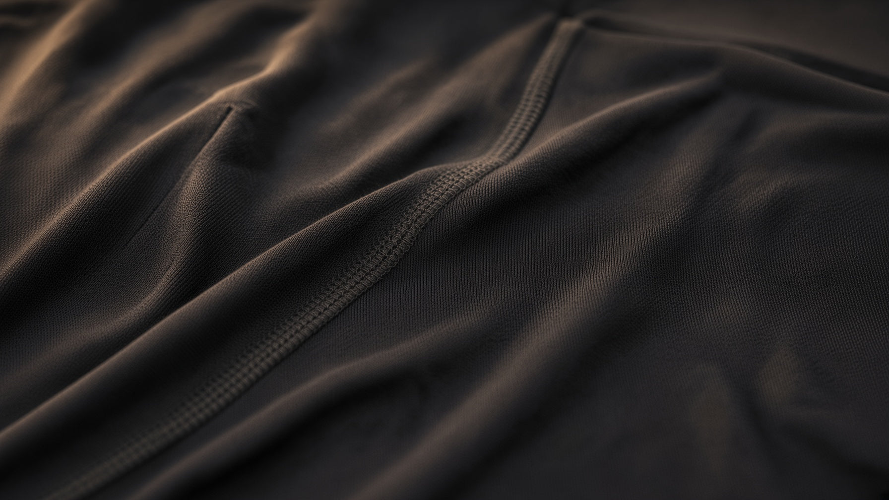 Folded Oakman fabric in close-up under warm side light.